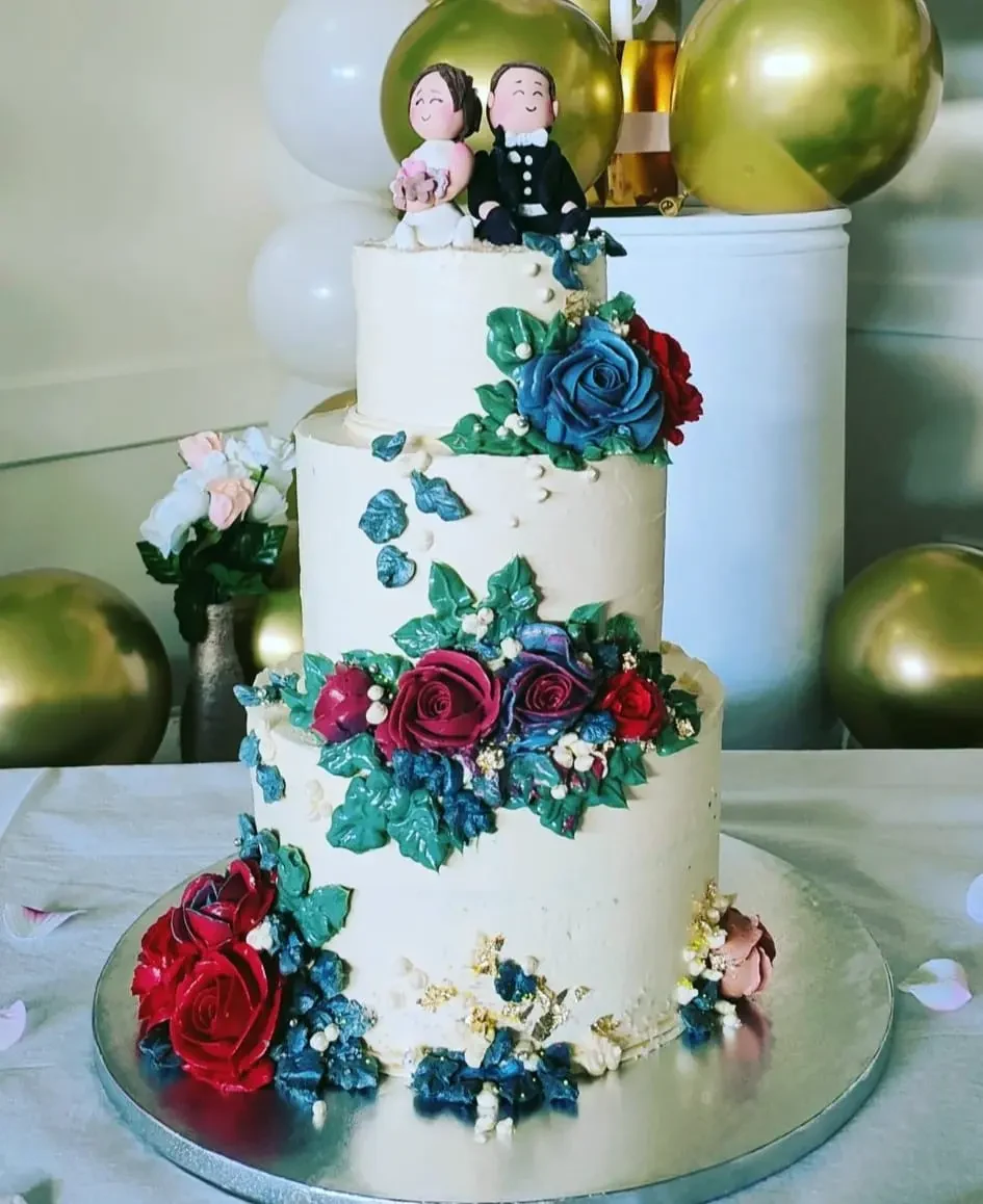 Three tier floral wedding cake with couple topper made in Dunedin by The Cake Lady Dunedin