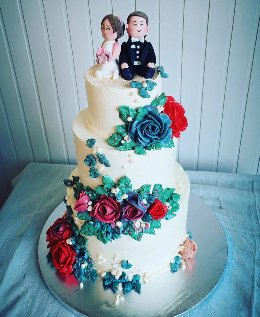 Colourful Floral Bride-and-Groom Wedding Cake Angled View by Criollo Designer Cakes in Dunedin, Otago