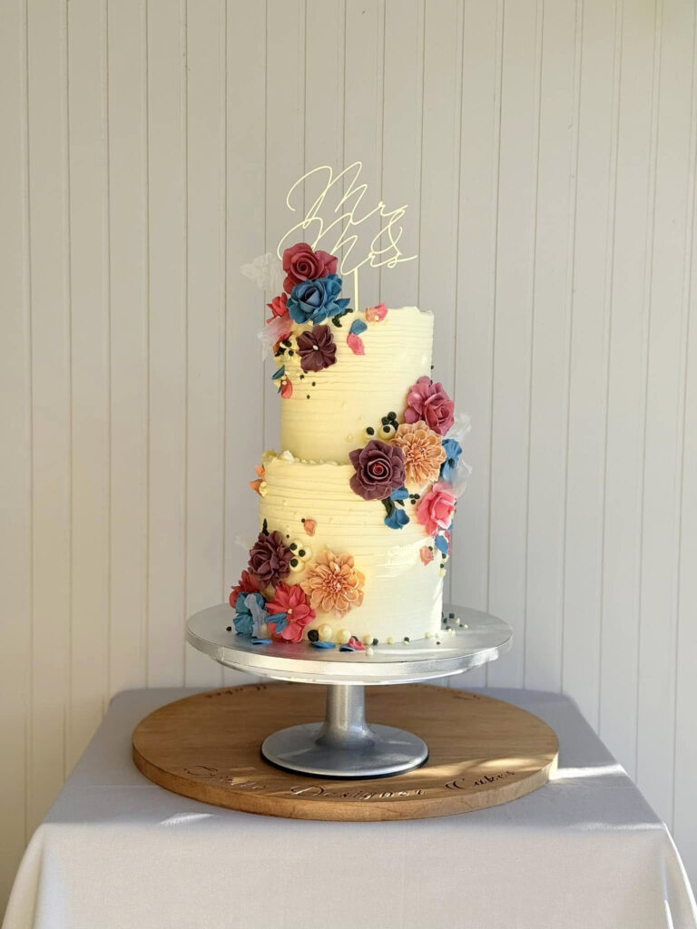 Colourful Floral Cascade Tall Wedding Cake by Criollo Designer Cakes in Dunedin, Otago