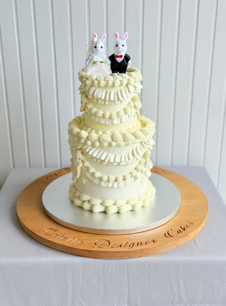 Couple Topped Wedding Cake With Lambeth Piping